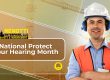 Construction worker wearing ear protection on a job site during National Protect Your Hearing Month.